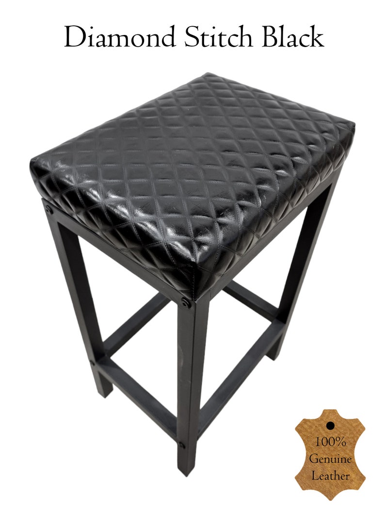 May include: Black bar stool with a diamond-stitched leather seat. The stool has a simple, sturdy design with a square base and four legs. The seat is padded and comfortable. The stool is made of high-quality materials and is built to last. 100% Genuine Leather.