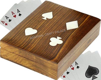 May include: A wooden box with a hinged lid, decorated with inlaid white card suit symbols. The box is open and a deck of playing cards is partially visible.