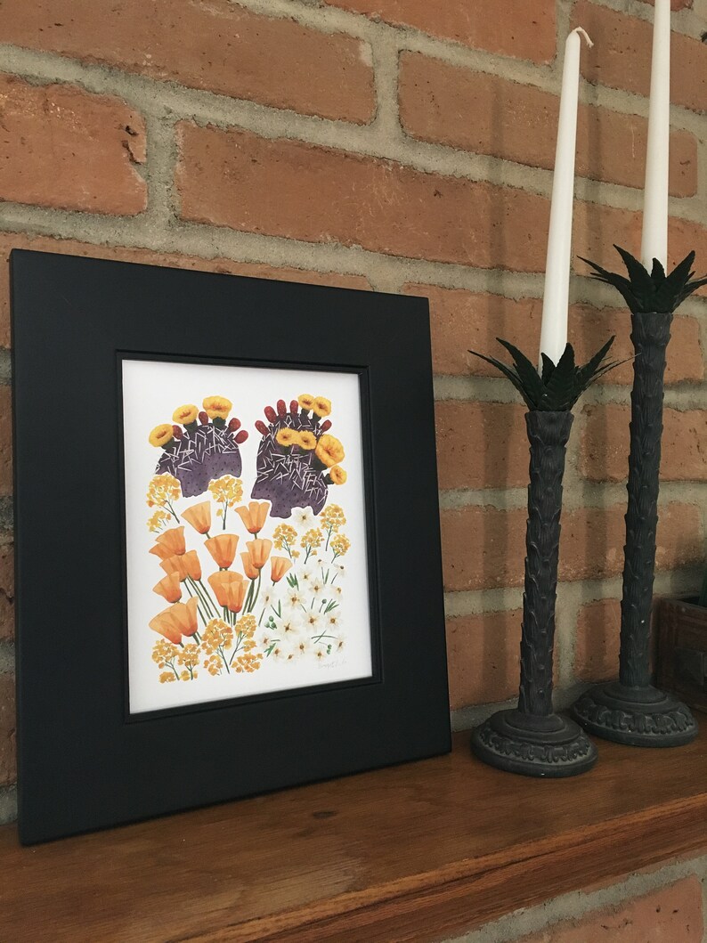 May include: A framed botanical print featuring a cluster of orange and yellow flowers, including poppies and prickly pear cactus blossoms, on a white background.