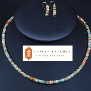 May include: A multi-colored turquoise and coral beaded necklace with matching earrings. The necklace is on a black surface with a logo that reads "Roslyn Sanchez Jewelry Designer".