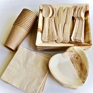 May include: A set of disposable tableware made from palm leaves. The set includes plates, bowls, forks, knives, and spoons. The tableware is brown and natural in color.