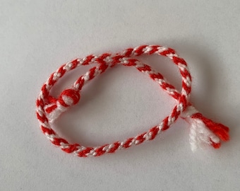 Red and white striped bracelet/anklet.