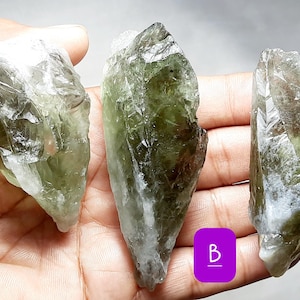 May include: Three green and white crystal points, labeled A, B, and C.