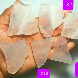 May include: Six pieces of clear, pale pink rose quartz crystals. The crystals are various shapes and sizes. The crystals are labeled with numbers Z6, Z7, Z8, Z9, Z10, and Z11.