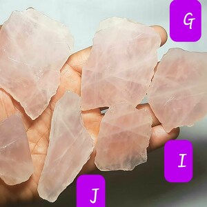 May include: Seven pieces of raw rose quartz crystals in various shapes and sizes. The crystals are a pale pink color and have a translucent appearance.