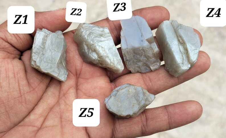 May include: Five rough, translucent, light blue-grey stones labeled Z1, Z2, Z3, Z4, and Z5. Each stone has an irregular, jagged shape with visible crystalline textures and smooth, reflective surfaces. The stones vary in size and angularity.