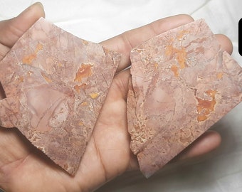 May include: Two pieces of red and orange patterned stone, labeled A and B.