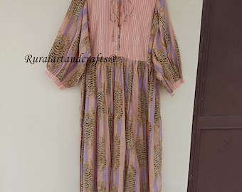 May include: A long, pink and purple striped dress with a tiger print. The dress has a tie at the neck and puffed sleeves.