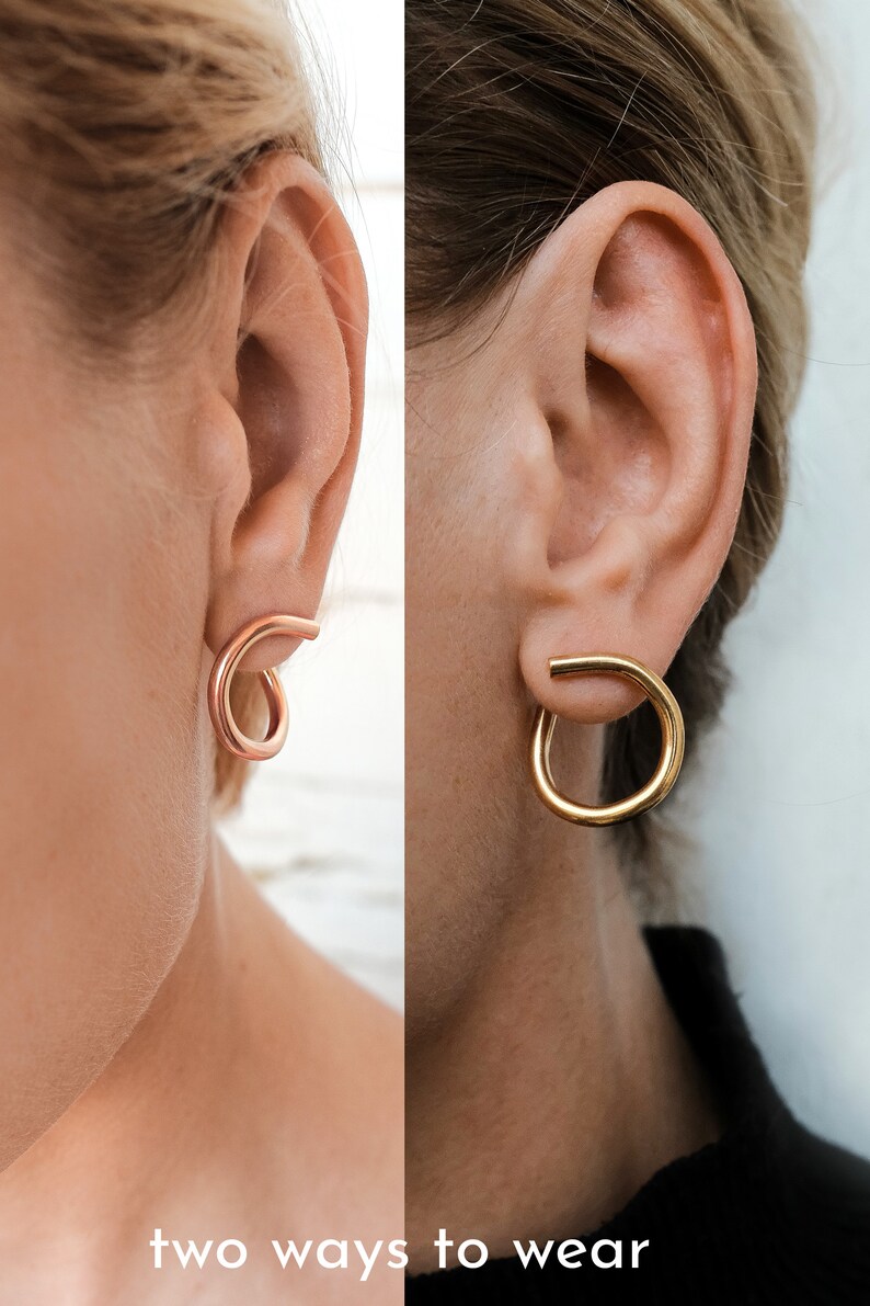 May include: A split image shows two earrings. On the left, a rose gold earring is looped. On the right, a gold hoop earring is worn. The text "two ways to wear" is at the bottom.