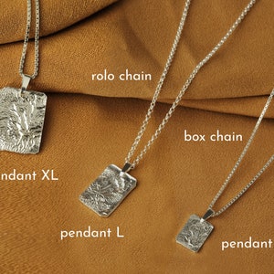 May include: Three silver necklaces with different chain styles and pendant sizes. The top necklace features a rolo chain and a large pendant labeled "pendant XL". The middle necklace features a box chain and a medium pendant labeled "pendant L". The bottom necklace features a box chain and a small pendant labeled "pendant M".