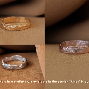 May include: Three textured metal rings in gold, rose gold, and silver. The rings are all the same style, with a rough, organic texture. Other colors are available in the section "Rings" in our shop.