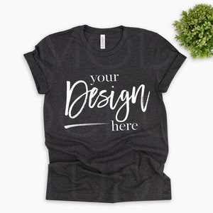 May include: A dark gray t-shirt with the text "your design here" in white.