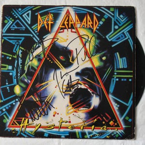Def Leppard signed Hysteria album cover Signed by 4 Very Rare  Registered Dealer  Photo proof at signing time.