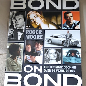 Roger Moore GESIGNEERD Bond-on-obligatie GESIGNEERD boek Limited ondertekende editie Authentiek gegarandeerd geregistreerde dealer COA