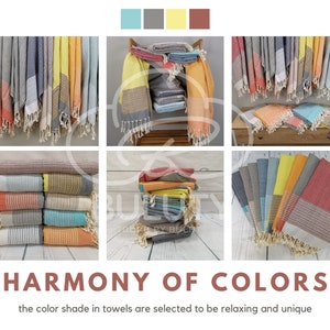 May include: A collection of colorful Turkish towels, displayed in various ways, with a variety of colors including red, orange, yellow, blue, and gray. The towels are made of cotton and have a fringed edge. The image includes the text "HARMONY OF COLORS" and "the color shade in towels are selected to be relaxing and unique".