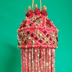 Red and gold jewels on the diagonal cover this woven red yarn trim Christmas ornament with 6&quot; gold and red beaded fringe (3&quot; ball)