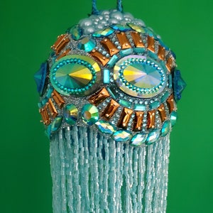 Light turquoise blue and copper jeweled trim encircle this striking Christmas ornament with 6&quot; beaded fringe (3&quot; ball)