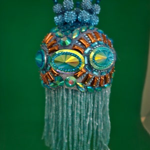 Large AB turquoise blue and copper designs encircle this Christmas ornament with a pave bead crown and 3&quot; turquoise beaded fringe (3&quot; ball)