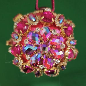 Giant iridescent pink jewel medallions decorate this pink satin Christmas ornament (3&quot; ball)
