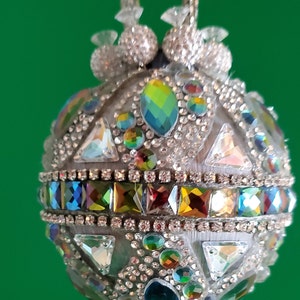 Silver satin ornament embellished with rhinestones and multicolored and triangular rhinestone jewels (3&quot; ball)