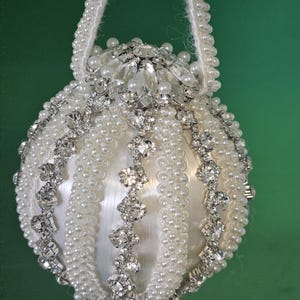 Pearl trim and rhinestone trim decorate this spectacular Christmas or wedding ornament (3&quot; ball)