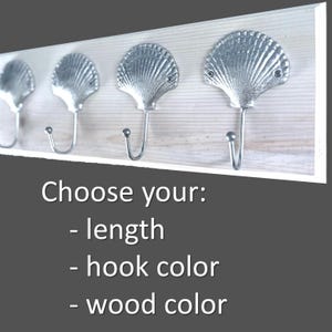 May include: A wooden coat rack with three silver seashell hooks. Choose your length, hook color, and wood color.
