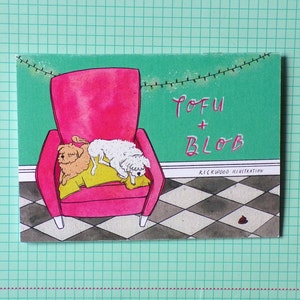 May include: A watercolor illustration of two dogs, one white and one brown, sleeping on a pink armchair. The background is a green wall with a string of lights and a checkered floor. The text "TOFU + BLOB" is written in black on the wall, with "RICKWOOD ILLUSTRATION" below it.