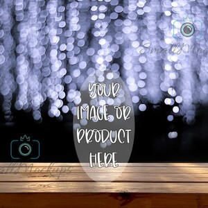May include: A wooden table top with a blurred background of white lights. The text "Your image or product here" is written in white on a circle.
