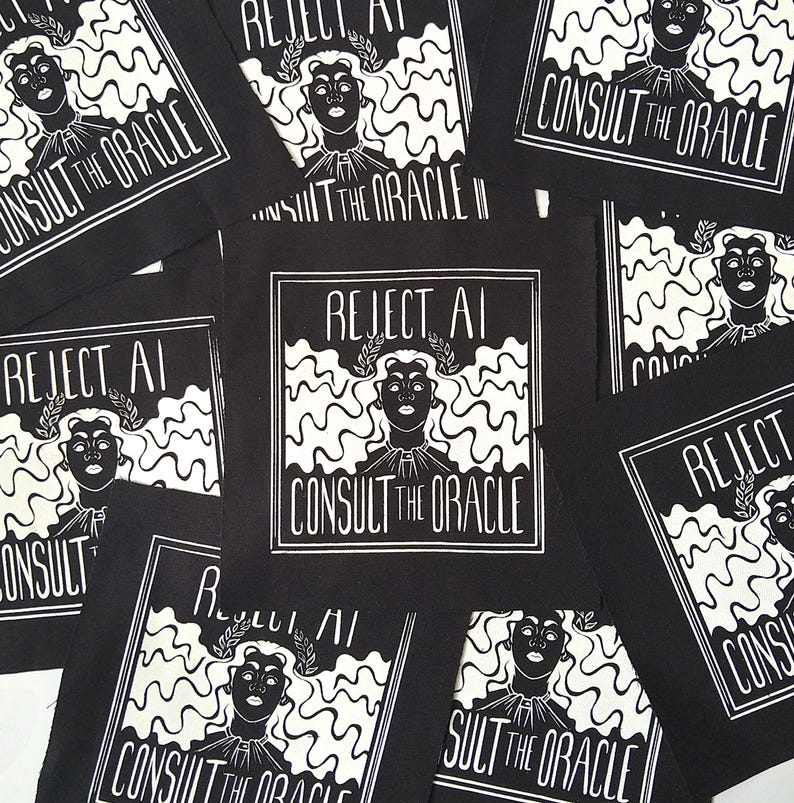 May include: A collection of square black fabric patches featuring a white screen-printed graphic of a person with wavy hair wearing a laurel wreath. The text REJECT AI and CONSULT THE ORACLE is printed in a bold, stylised font within a square border.