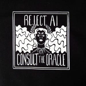 May include: A black fabric featuring a repeating white graphic print. Each square design displays the text REJECT AI at the top and CONSULT THE ORACLE at the bottom, surrounding a central illustration of a figure wearing a laurel wreath crown.
