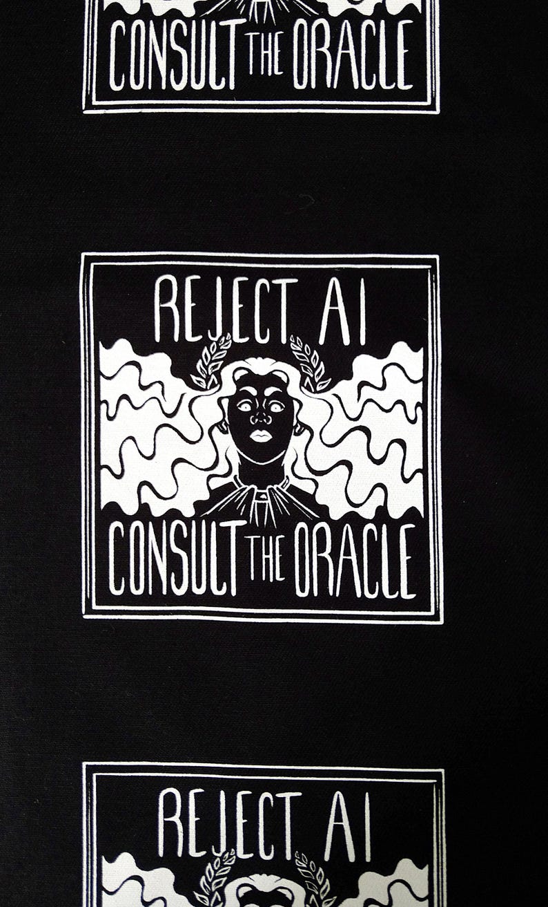 May include: A black fabric featuring a repeating white graphic print. Each square design displays the text REJECT AI at the top and CONSULT THE ORACLE at the bottom, surrounding a central illustration of a figure wearing a laurel wreath crown.