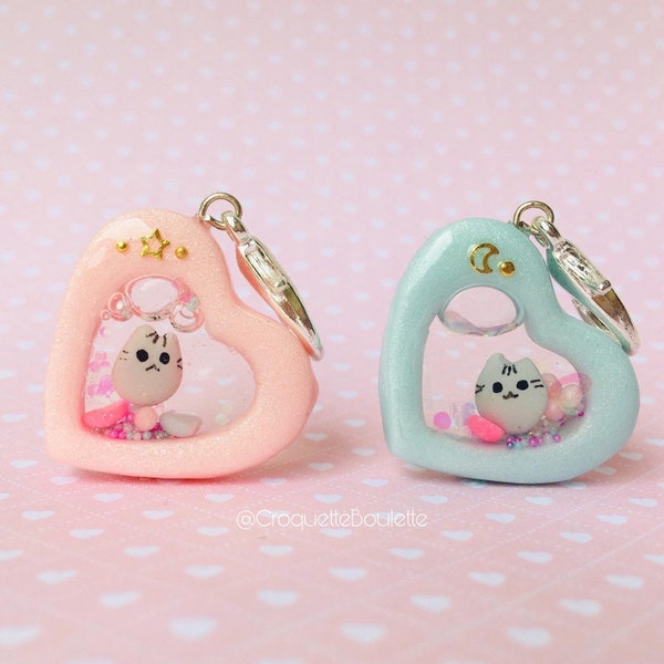 Pusheen charm shaker in the shape of a pink or blue heart for a keychain or bags, made of polymer clay and uv resin