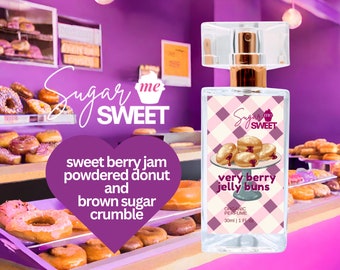 May include: A perfume bottle with a clear rectangular design and a gold-colored spray nozzle. The label features a pink and white checkered pattern and an illustration of jelly buns. The text reads "Sugar me Sweet" and "very berry jelly buns".