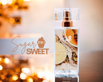 May include: A rectangular perfume bottle with a clear cap and gold accents. The label reads "Cocoa Butter & Honey" and "Organic Perfume 30ml (1 Fl. oz)." The brand name "Sugar Me Sweet" is also visible.