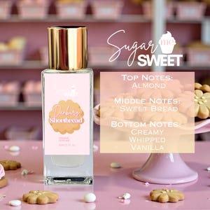 May include: A perfume bottle with a gold cap and a pink label featuring the text "Danbury Shortbread." The label also lists the top, middle, and bottom notes: almond, sweet bread, creamy whipped vanilla. The bottle is 30ml (1 fl oz).