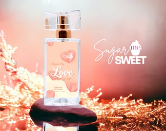 May include: A rectangular perfume bottle with a clear, square cap and gold-colored sprayer. The label features a heart design and the words "Inspired By Love, Don't Be Shy." The bottle is labeled "Organic Perfume" and is 1 fl oz.