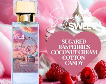 May include: A rectangular perfume bottle with a gold cap and a label featuring a boardwalk scene. The label reads "Boardwalk" and "Sugar Sweet." The image includes raspberries, whipped cream, and the words "Sugared Raspberries Coconut Cream Cotton Candy."