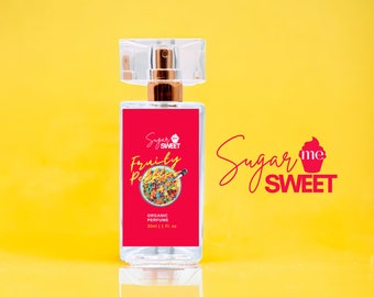 May include: A clear perfume bottle with a red label featuring the text "Sugar Me Sweet" and "Fruity Pebbles." The label also includes a colorful cereal graphic and the words "Organic Perfume." The bottle is 1 fl. oz. and has a clear cap.