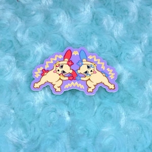 May include: Two cartoon animals with yellow fur, red and blue accents, and flowers on their heads are facing each other with their arms raised in a fighting pose. The animals are on a purple background with yellow lightning bolts around them.