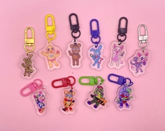 May include: Set of ten colorful keychains featuring characters from the popular video game franchise Five Nights at Freddy's. Each keychain features a different character, including Freddy Fazbear, Chica the Chicken, Bonnie the Bunny, Foxy the Pirate Fox, and more. The keychains are made of clear acrylic and have a metal ring for attaching to keys or bags.