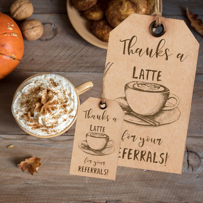 May include: Two brown gift tags with the text "Thanks a Latte for your Referrals!" and a drawing of a latte. The tags are hanging from twine.