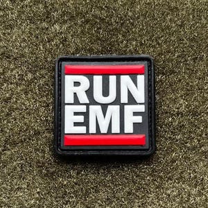 May include: A square patch with the words "RUN EMF" in white block letters on a black background. The letters are separated by two horizontal red bars. The patch is likely made of a durable material.