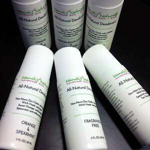 May include: White roll-on deodorant bottles with green and black text. The bottles are labeled "Nandi's Naturals All-Natural Deodorant" and list ingredients and scents like Orange & Spearmint, Lemon, and Fragrance Free. Each bottle is 3 fl oz.