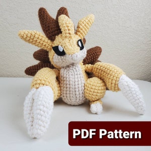 May include: A crocheted plush toy in tan, brown, cream, and white. The toy features large ears, a spiky back, and a long tail. The text "PDF Pattern" is displayed in a red box at the bottom of the image.