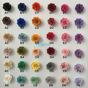 May include: A grid of thirty paper flowers in various colors, each labeled with a code from A1 to F6. The flowers are arranged in six rows and six columns, featuring shades of black, blue, orange, red, pink, purple, brown, green, yellow, and white.