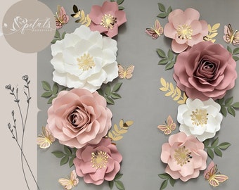 May include: Arrangement of paper flowers in shades of pink, white, and mauve, with gold accents and butterfly decorations. The flowers include roses and other floral designs, with green leaves. The text "Spetals Redefined" is in the upper left corner.