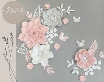 May include: A wall decor set featuring paper flowers in shades of pink and white, with butterflies and leaves. The flowers are layered and have a 3D effect. The text "Petals Redefined" is visible in the top left corner.
