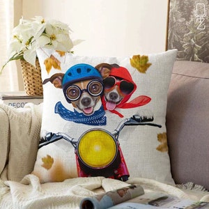 May include: Two dogs wearing helmets and sunglasses are riding a motorcycle. The dog in the front is wearing a blue helmet and a blue bandana. The dog in the back is wearing a red helmet and a red bandana. The motorcycle is red and has a yellow headlight.