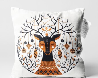 May include: White throw pillow with a black and gold illustration of a deer wearing a sweater with ornaments hanging from its antlers. The text "Thanks!" is printed on a small tag attached to the pillow.