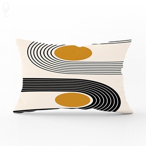 May include: A cream-coloured pillow with a black and white geometric pattern and two mustard yellow circles.